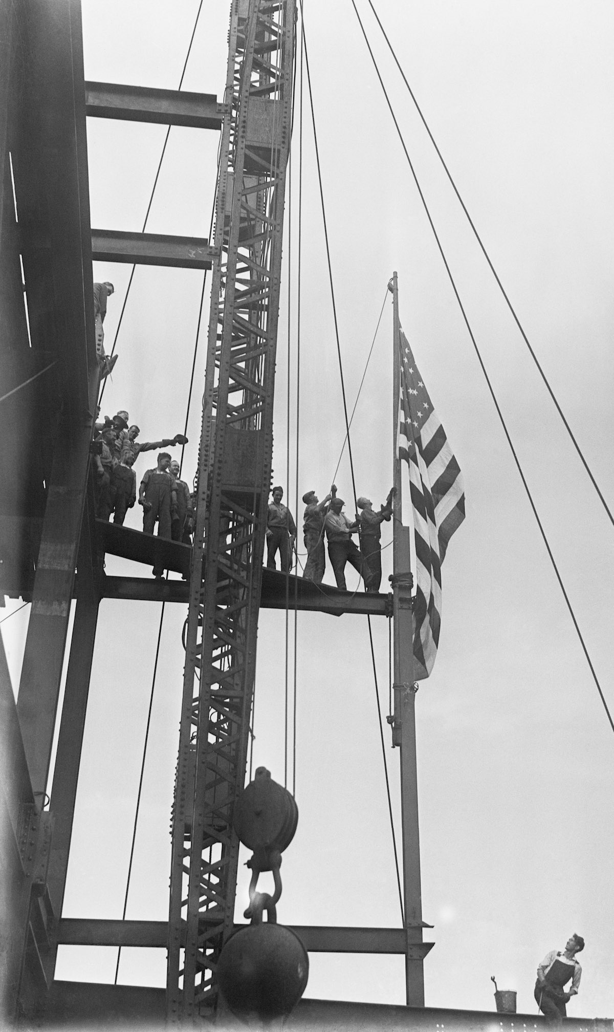 Workmen Raise Flag At The Empire State