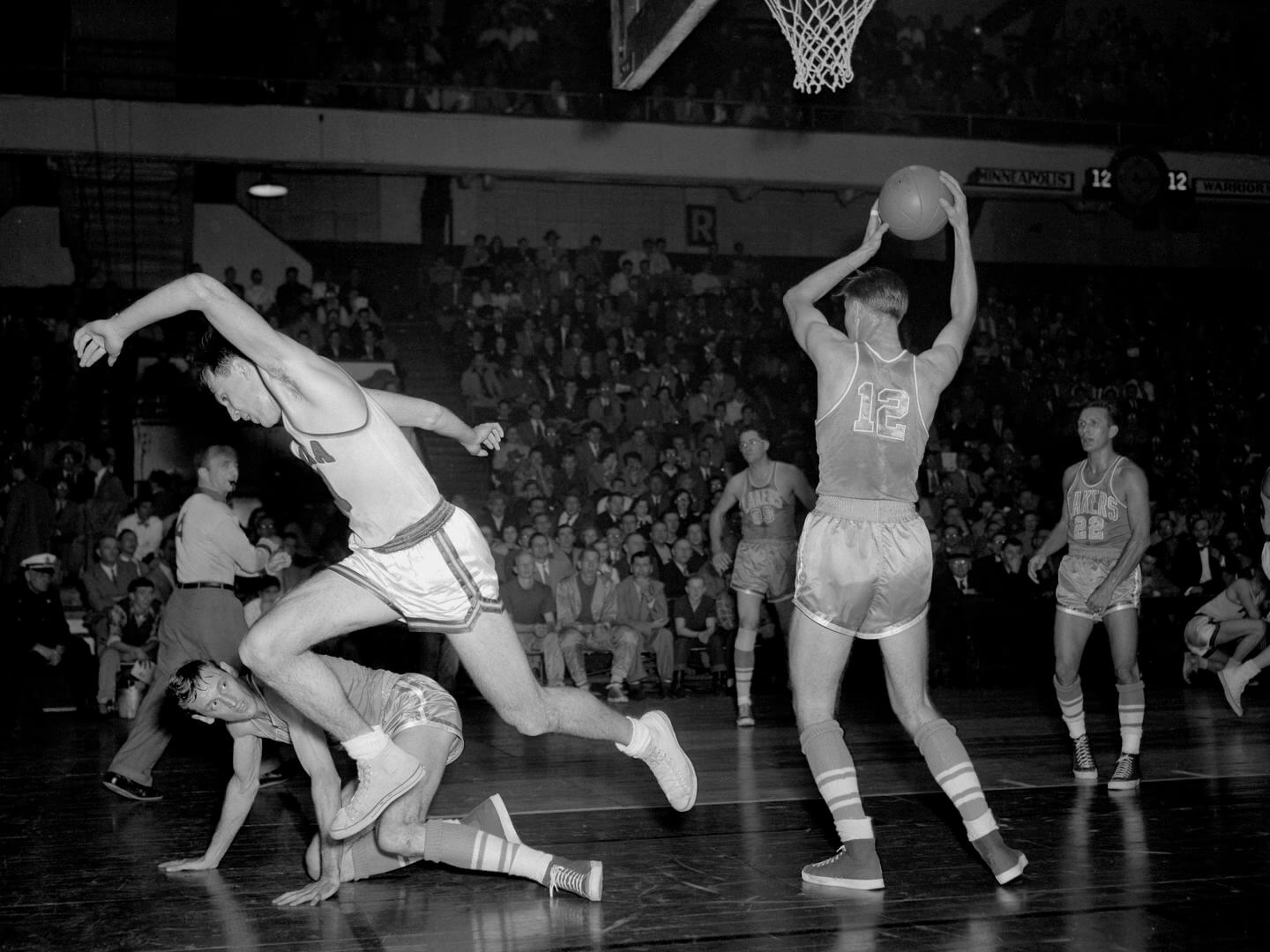 PHILADELPHIA, PA - DECEMBER 21: Howie Schultz #12 of the Minneapolis Lakers rebounds against the Philadelphia Warriors on December 21, 1951 at the Philadelphia Civic Center in Philadelphia, Pennsylvania. NOTE TO USER: User expressly acknowledges and agrees that, by downloading and or using this photograph, User is consenting to the terms and conditions of the Getty Images License Agreement. Mandatory Copyright Notice: Copyright 1951 NBAE (Photo by Charles T. Higgins/NBAE via Getty Images)