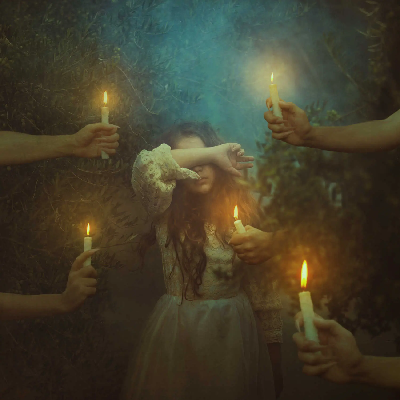 Fotografía de una niña con manos llenas de velas encendidas